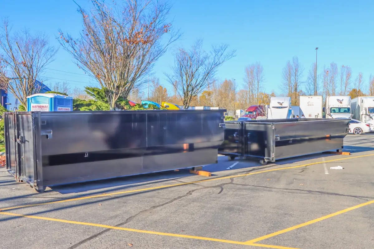 Professional dumpster rental service with roll-off container on residential driveway in Ranson corporation